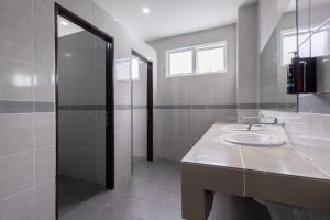 a bathroom with a sink and a shower and a mirror at DB Stay in Kuching +38 photos