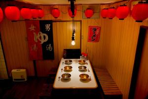 a table with four bowls of food on it at ご当地ラーメン食べ放題 "The RAMEN HOTEL" -京都嵐山- in Kyoto +15 photos
