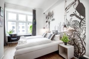 a living room with a white couch and a large window at Pyjama Park Schanzenviertel in Hamburg