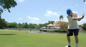 a man is flying a kite in a field at Celuisma Playa Dorada All Inclusive in Sampiño
