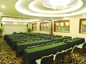 a conference room with green chairs and a white ceiling at New Friendship Hotel in Luoyang