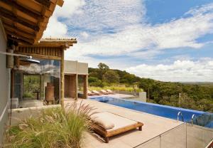 a view of a house with a swimming pool at Capim do Mato Pousada & Spa by L'Occitane in Serra do Cipo