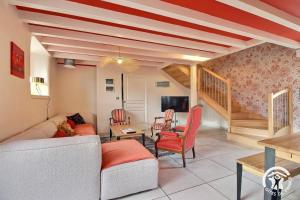 una sala de estar con un sofá y una mesa en Le pressoir, en Guidel