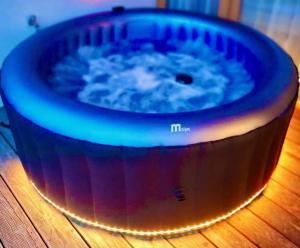 a hot tub sitting on top of a wooden table at DESIGN RETREAT Schneeberg - Singlestudio, Gartenstudio, Whirlpool-Suite oder Maisonette-Suite in Puchberg am Schneeberg +85 photos