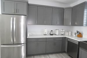 eine Küche mit grauen Schränken und einem Edelstahlkühlschrank in der Unterkunft Near Disneyland and Huntington Beach, Little Saigon in Garden Grove