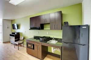 a kitchen with a black refrigerator and a sink at Studio 6-Sweetwater, TX in Sweetwater