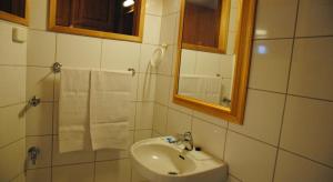 a bathroom with a sink and a mirror and towels at Sininen Talo in Naantali