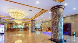 a lobby with columns and a chandelier in a building at Datong Tiangui International Hotel in Datong