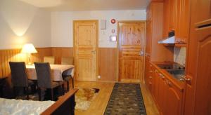 a small kitchen with a table and a dining room at Sininen Talo in Naantali
