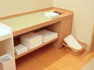 a room with a shelf with towels on it at Bessou Kakei in Morioka