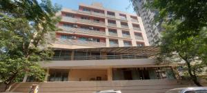a large building with a balcony in front of it at SATVIK STAy in Navi Mumbai