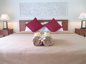 a bedroom with a large bed with flowers on it at Mona Homestay in Sanur