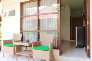 a room with a table and chairs and a window at Mona Homestay in Sanur