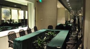 a conference room with a green table and chairs at Jinjiang Inn Shanghai Qingpu in Qingpu