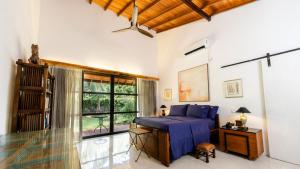 a bedroom with a bed and a large window at Villa Blue Lotus Katunayake in Katunayake