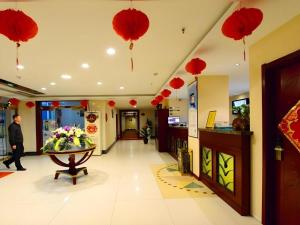 a lobby with red paper lanterns hanging from the ceiling at GreenTree Inn Shandong Yantai Penglai Pavilion Bus station Express Hotel in Penglai