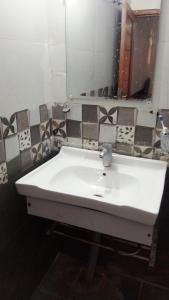 a bathroom with a white sink and a mirror at Murree Oaks Tulip Block in Murree +17 photos