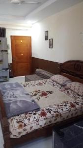 a bedroom with a bed with a blanket on it at Murree Oaks Tulip Block in Murree