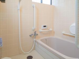 une salle de bain avec une baignoire et un lavabo dans l'établissement ゲストハウス634庵, à Sango 14 autres photos