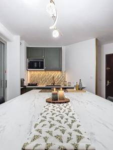 a large kitchen with a large white counter top at L'Ecrin du Lydia - Fêtez Noël avec Alto Service in Le Barcarès