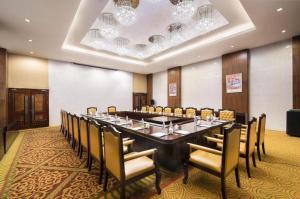 a large conference room with a long table and chairs at Lhasa Hotel in Lhasa