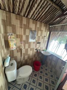 a bathroom with a toilet and a sink at Người Giữ Rừng- Nhà hàng và Du Lịch Sinh Thái in Bình Ðại +30 photos