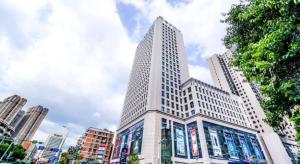 a tall white building in a city at City Comfort Inn Hotel Nanning Nanhu Park Macun Metro Station in Nanning