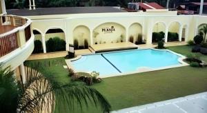 a large house with a large swimming pool at Planta Centro Bacolod Hotel & Residences in Taculing Hacienda