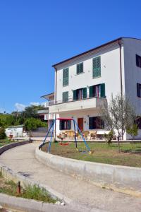 an empty playground in front of a building at B&b La Nuova Stella in Perano