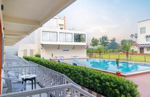 a balcony with a swimming pool and a building at Zone Connect by The Park Patna 