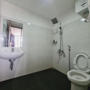 a bathroom with a toilet and a sink at Menoreh Farm Stay Samigaluh Kulonprogo in Kalirejo +39 photos