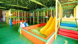 a colorful playground with slides and fruit on it at Jimmers Mountain Resort in Puncak