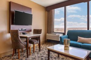 a hotel room with a couch and a table at Radisson Hotel Southfield-Detroit in Southfield