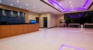 a lobby of a hotel with a sign on the wall at Ewha Hotel in Jeju