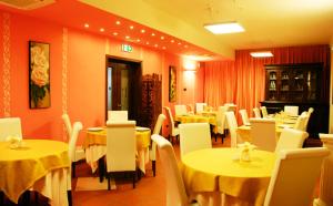 a restaurant with yellow tables and white chairs and tables and tablesktop at Hotel San Paolo in Manduria