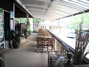 ein Restaurant mit Holztischen und Stühlen in einem Gebäude in der Unterkunft Baan Suan Sook Resort in Chaweng