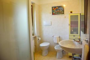 a bathroom with a white toilet and a sink at B&b La Nuova Stella in Perano