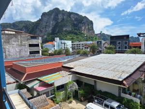 a city with buildings and a mountain in the background at Lalisa Hotel Aonang in Ao Nang Beach