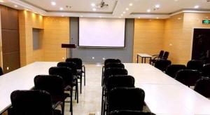 a conference room with a white table and chairs at Jinjiang Inn Pingyao Branch in Pingyao