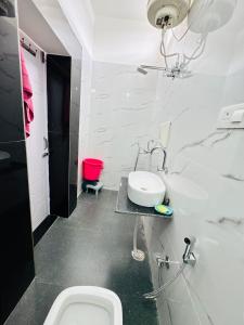 a bathroom with a toilet and a sink at Panwar peaceful homestay in Jhājra