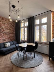 a living room with a table and chairs at UNESCO Loft House 24h Tarnowskie Góry Rynek 5 min in Tarnowskie Góry