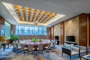 a large dining room with a table and chairs at Kempinski Hotel Guiyang in Guiyang