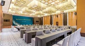 a large room with rows of tables and chairs at Dajiuhua Hotel in Chizhou
