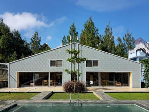 a white house with a tree in front of it at Villa Cannary in Tegalharendong