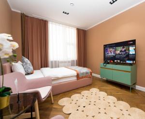 a hotel room with a bed and a flat screen tv at Amgun Hotel Ulaanbaatar in Ulaanbaatar