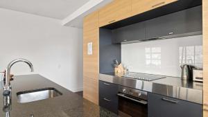 a kitchen with a sink and a counter top at Marina Quarters 406B in Queenstown