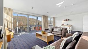 a living room with a couch and a table at Marina Quarters 406B in Queenstown