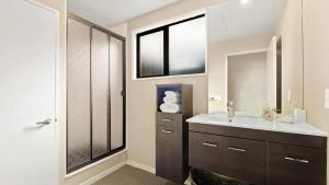 a bathroom with a sink and a mirror at Couple’s Retreat in Queenstown