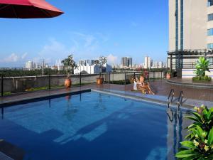 a large swimming pool on top of a building at BaoHua Harbour View Hotel in Haikou