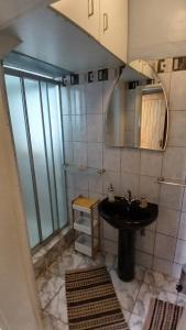 a bathroom with a sink and a mirror at John-Lou's One-bedroom Apartment in Windhoek +26 photos